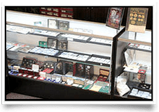 Display cases filled with collectible card game boxes and accessories.