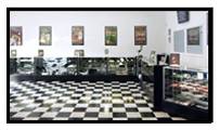 Retro diner with black and white checkered floor and vintage decor.
